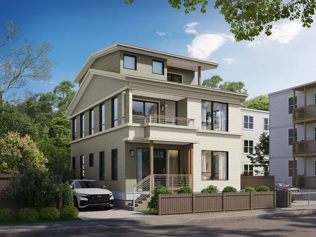 a front view of a residential apartment building with a yard