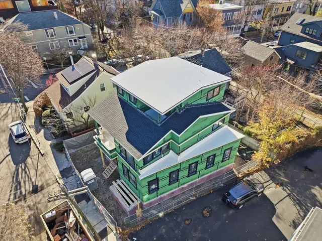 an aerial view of a house with a yard