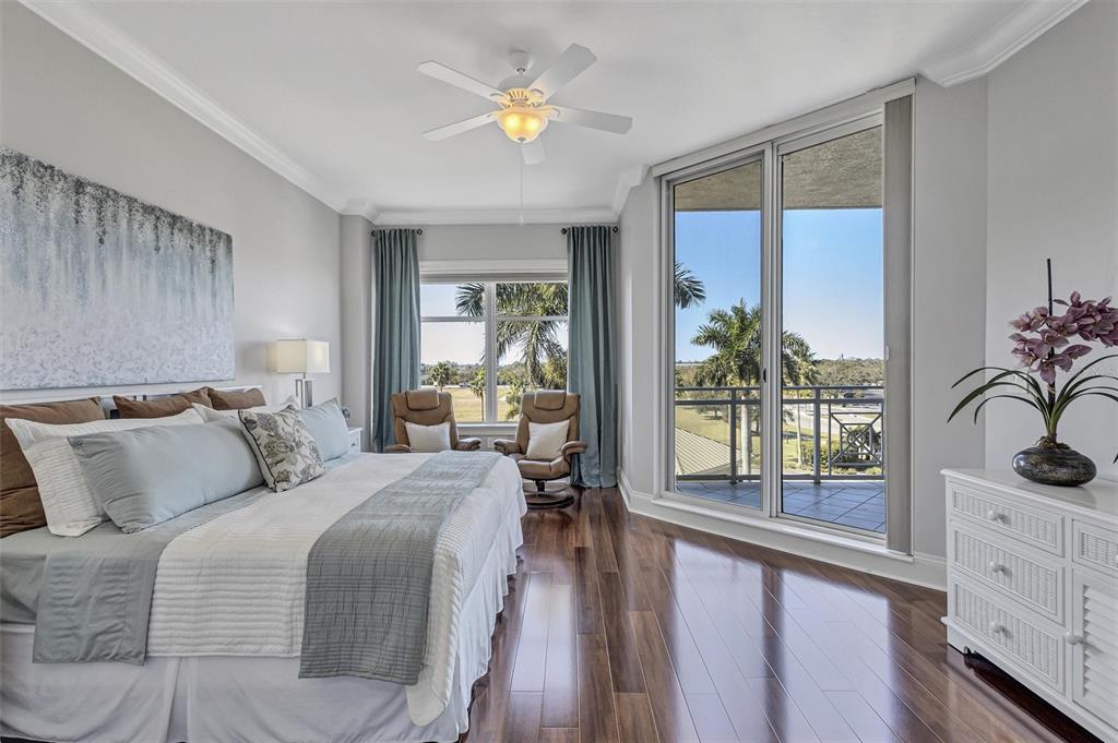 140 Riviera Dunes Way, Unit 206 Palmetto, FL 34221 - Photo 14 of 46 a bedroom with a large bed and a large window with the outer view