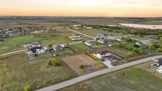 an aerial view of a residential houses with outdoor space