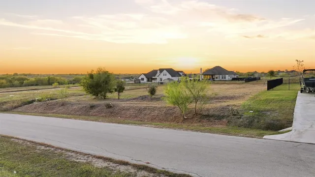 an aerial view of a houses with outdoor space and ocean view