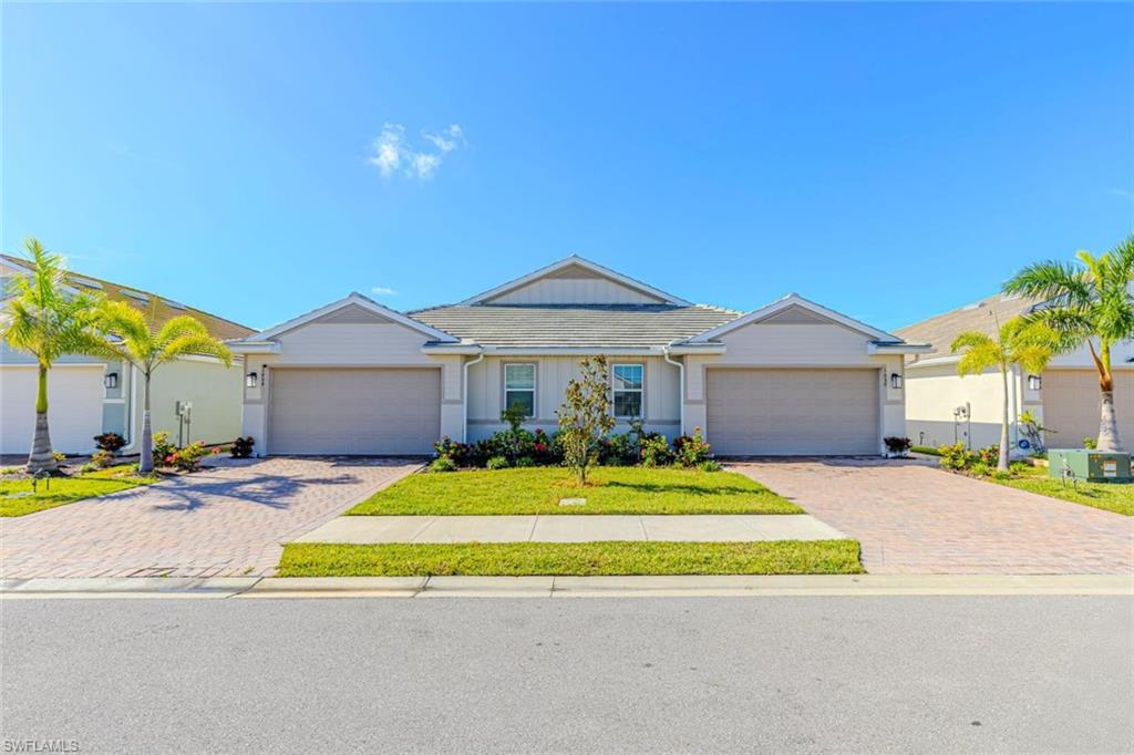 Ranch-style home with a front lawn, driveway, and a garage