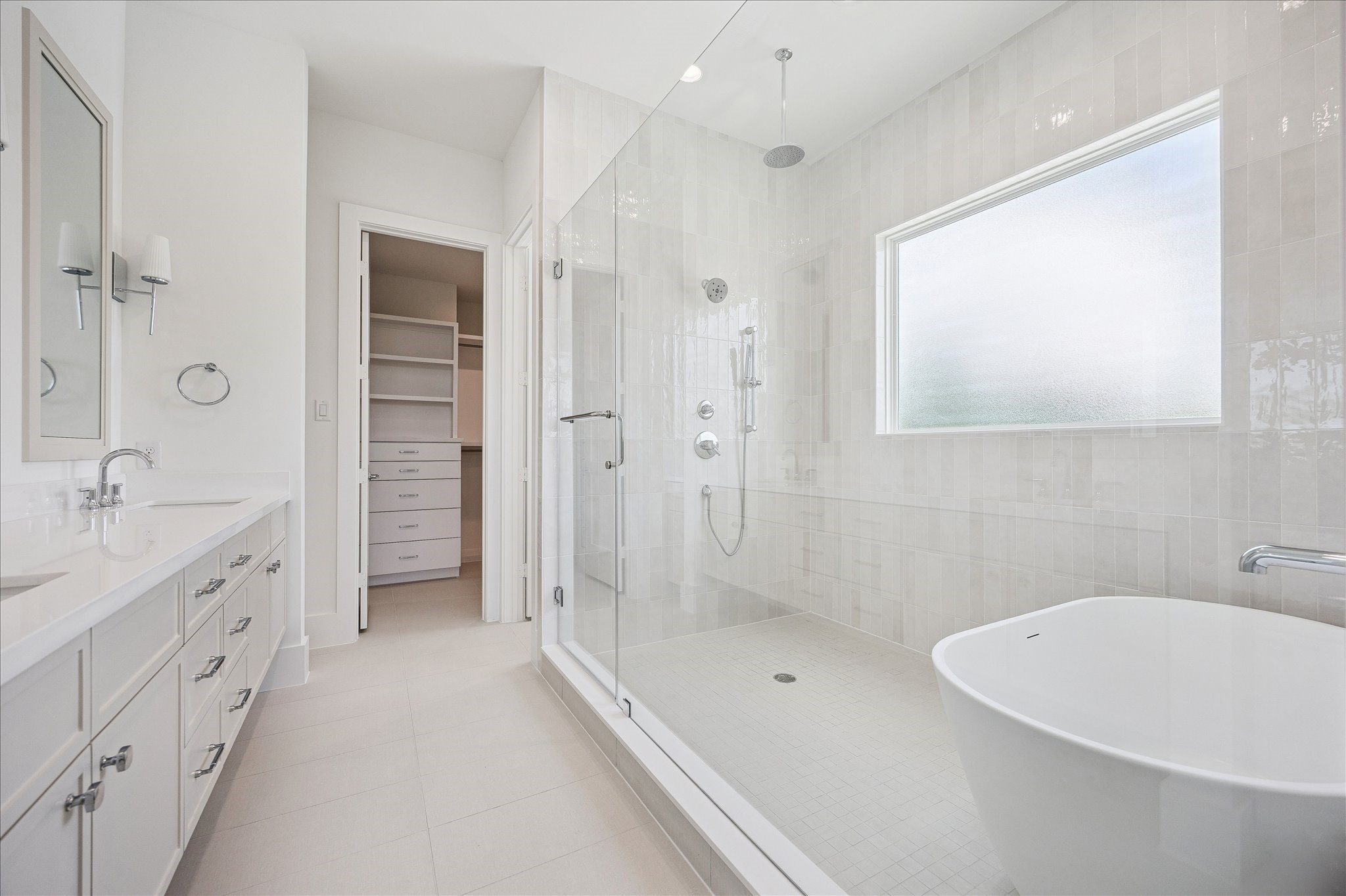 306 Fowler Street Houston, TX 77007 - Photo 16 of 29 Spa-inspired primary bath with freestanding soaking tub, oversized shower and designer finishes.