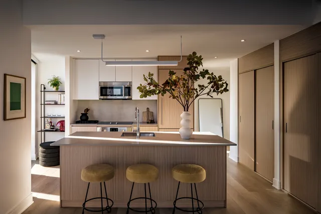 a kitchen with stainless steel appliances granite countertop a sink and a refrigerator