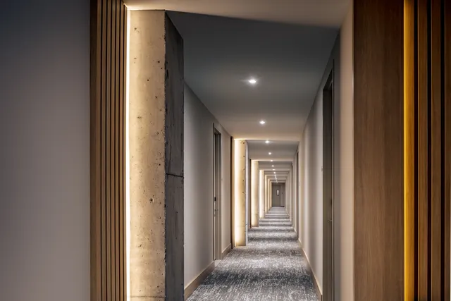 a view of a hallway with a livingroom and entryway