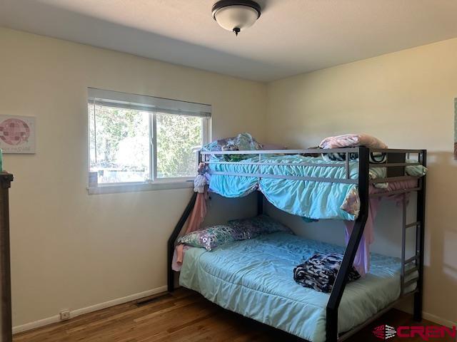 726 East 3rd Street Cortez, CO 81321 - Photo 10 of 20 a bed sitting in a bedroom next to a window