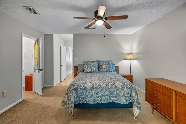 a bedroom with a bed and a lamp