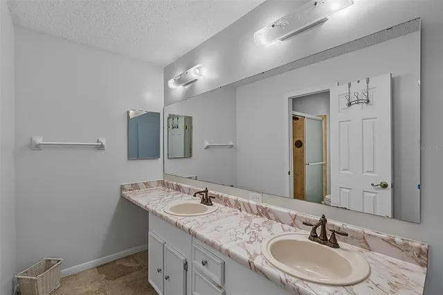 a bathroom with 2 sink and a mirror