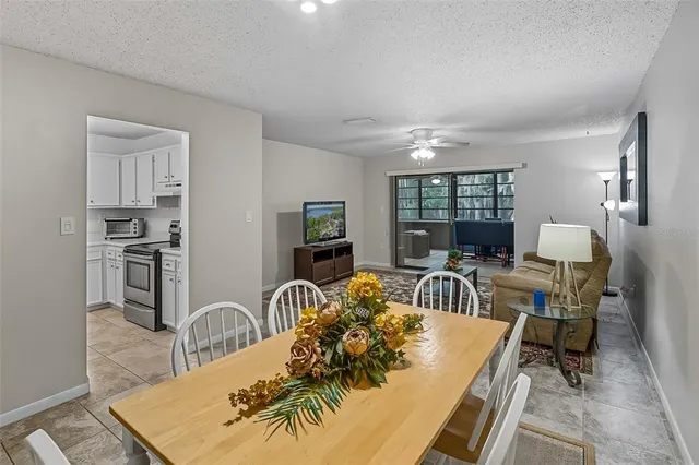 a living room with furniture a rug a fireplace and windows