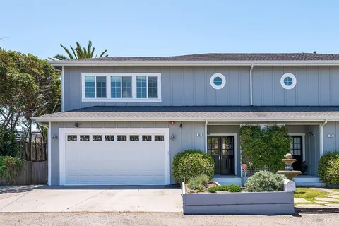 front view of a building with potted plants