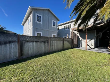 a view of a house with a wooden fence