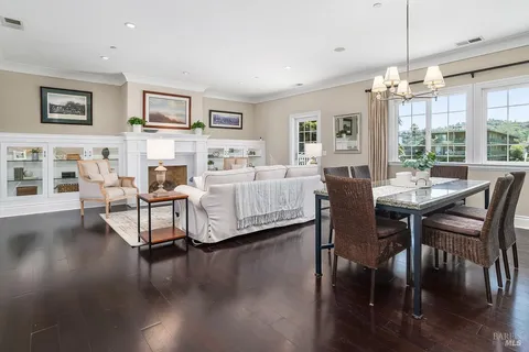 a living room with fireplace furniture and a wooden floor