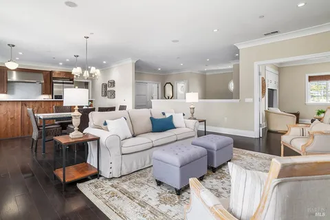 a living room with furniture and a chandelier
