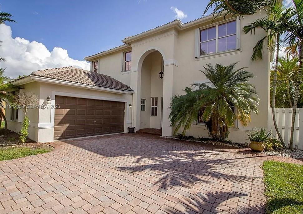 19416 Southwest 25th Court Miramar, FL 33029 - Photo 2 of 10 a front view of a house with a yard and garage