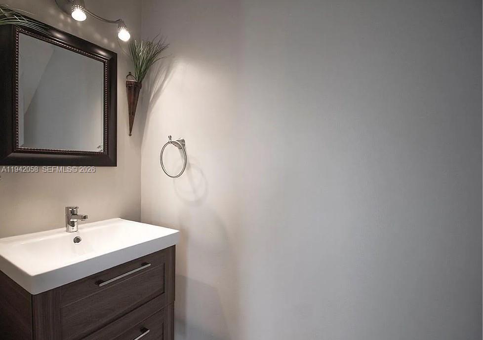 19416 Southwest 25th Court Miramar, FL 33029 - Photo 8 of 10 a bathroom with a sink vanity and mirror