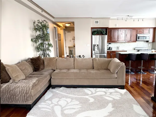 a living room with furniture and a kitchen view