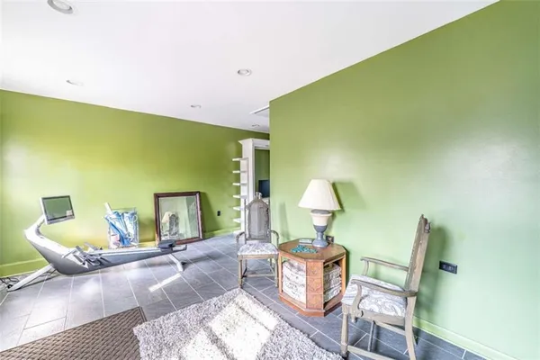 a living room with furniture and a lamp