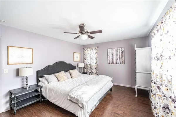 a bedroom with a large bed and a window