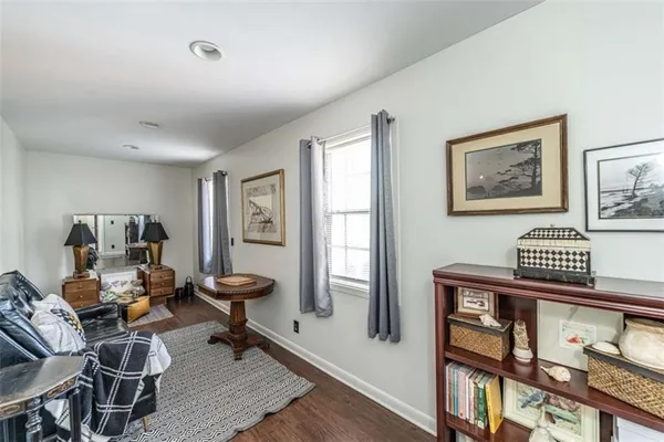 a bedroom with bed and wooden floor