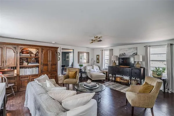 a living room with furniture windows and a chandelier