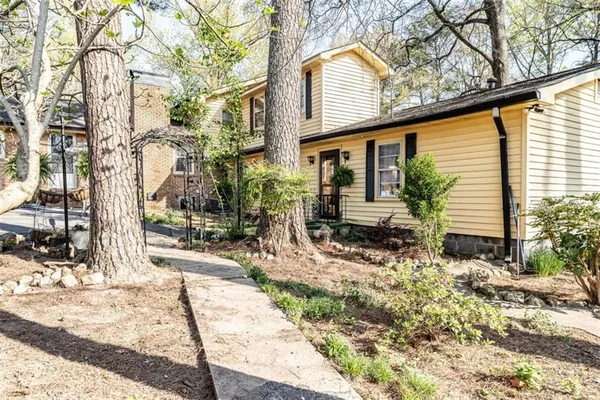a backyard of a house with yard and outdoor seating