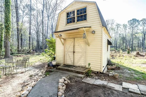 a view of a house with backyard and sitting area