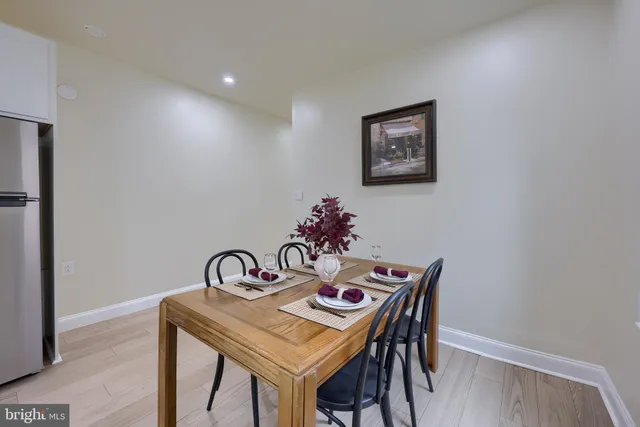 a view of a dining room with table and chairs