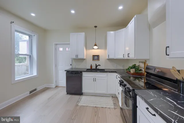 a kitchen with a sink stove and cabinets