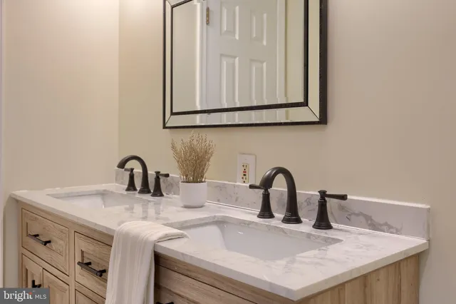 a large bed sitting in a bedroom next to a window