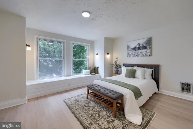 a bedroom with a bed and a rug