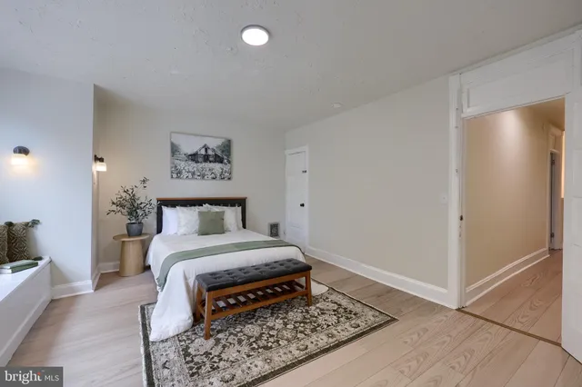 a spacious bedroom with a large bed and a large window