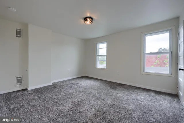 an empty room with a empty space and windows