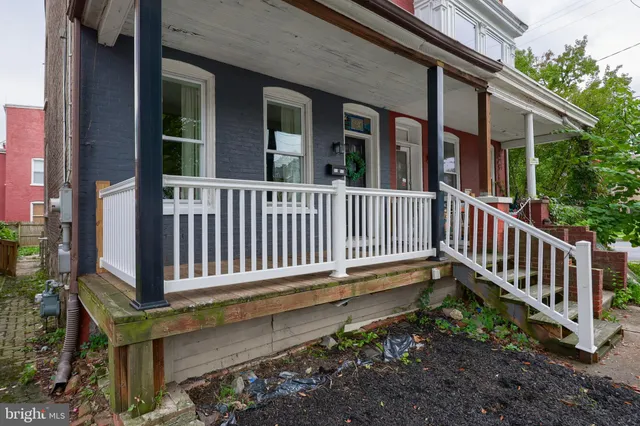 a view of a house with a small deck