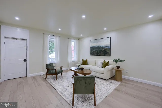 a living room with furniture wooden floor and windows
