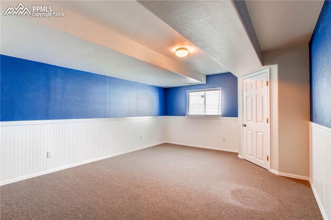12330 Motley Road Peyton, CO 80831 - Photo 21 of 27 Charming Bedroom #5 has a walk in closet and is also in the basement