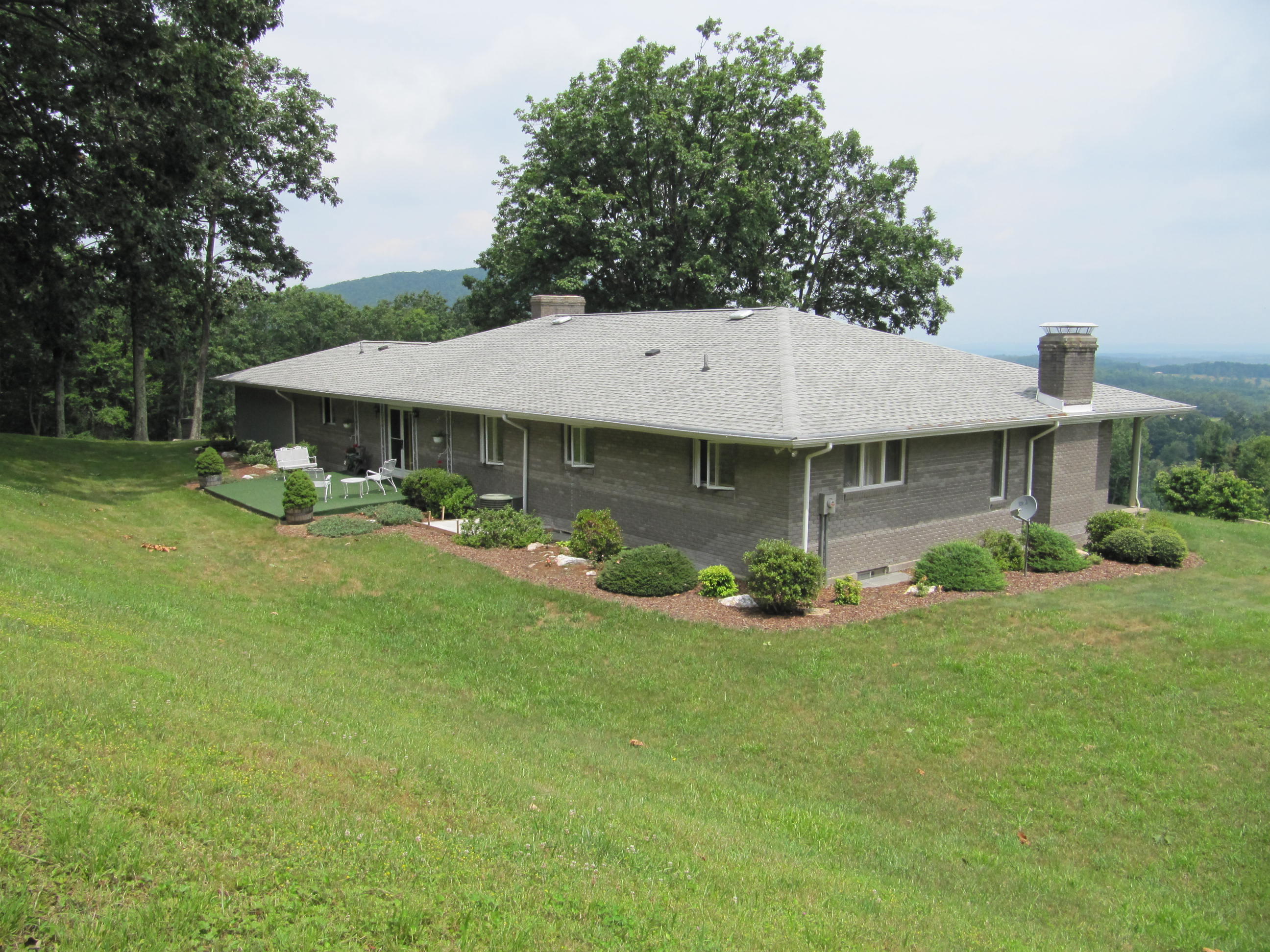 960 Tuggles Gap Road Southwest Floyd, VA 24091 - Photo 8 of 95 a view of a white house with a yard and sitting area