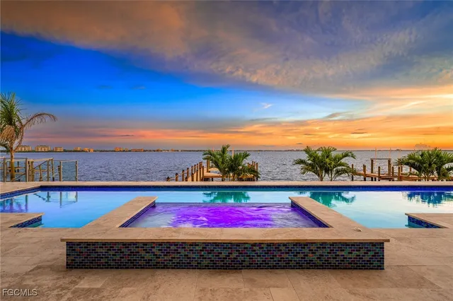 a view of a dining room with furniture a chandelier and wooden floor