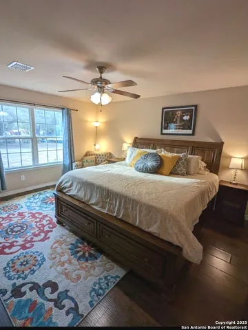 a bedroom with a bed and a flat tv screen on the dresser