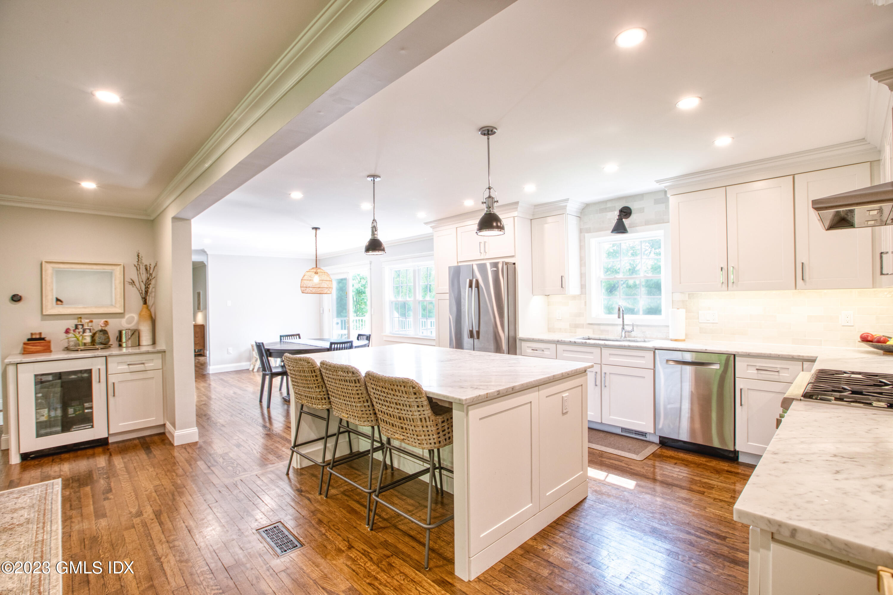 340 Webbs Hill Road Stamford, CT 06903 - Photo 12 of 36 a kitchen with a table chairs stove a sink dishwasher and cabinets with wooden floor
