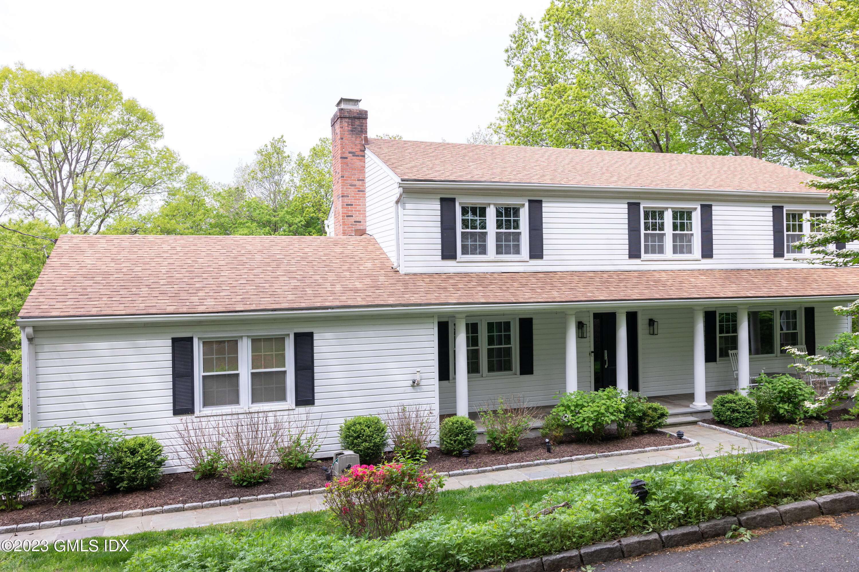 340 Webbs Hill Road Stamford, CT 06903 - Photo 2 of 36 a front view of a house with garden and porch