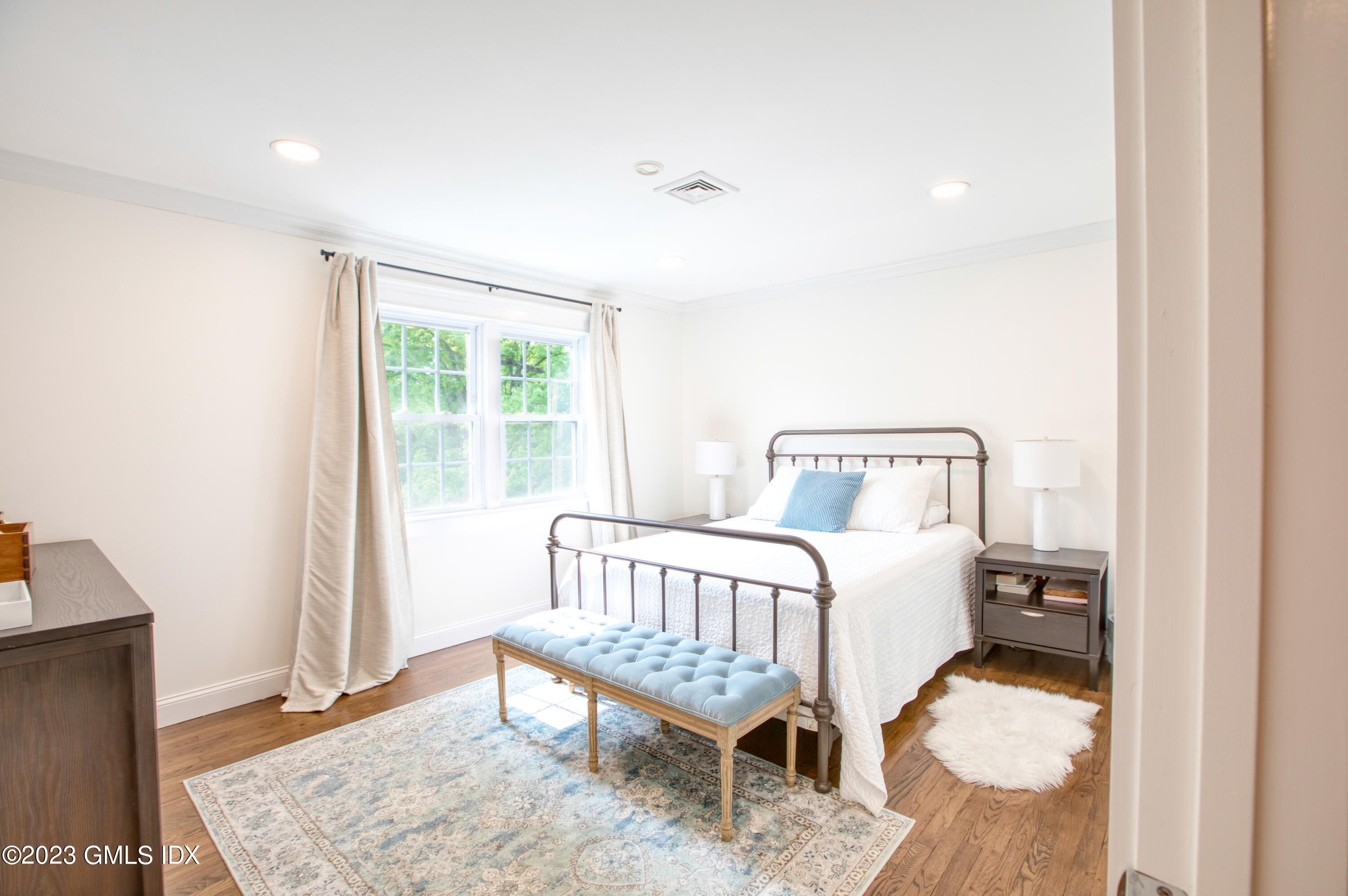 340 Webbs Hill Road Stamford, CT 06903 - Photo 28 of 36 a bedroom with a bed and wooden floor
