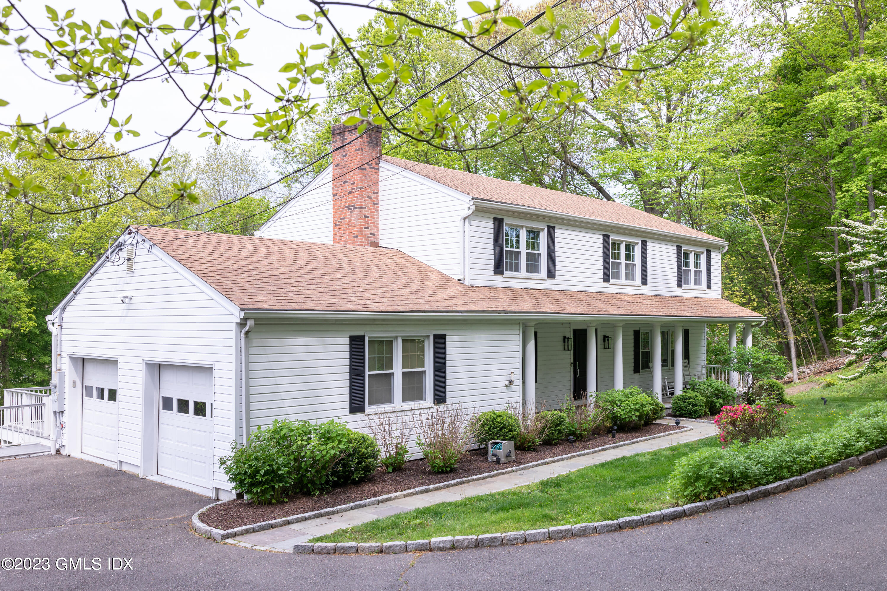 340 Webbs Hill Road Stamford, CT 06903 - Photo 3 of 36 a front view of a house with a yard and potted plants