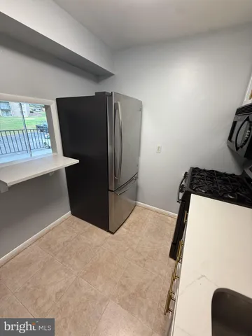 a kitchen with stainless steel appliances a refrigerator and a stove