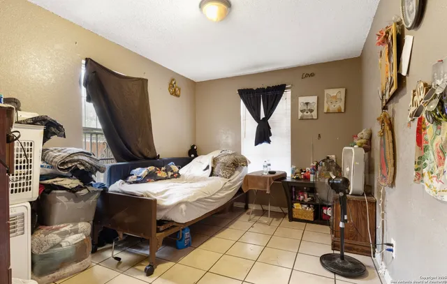 a bedroom with bed and a flat tv screen