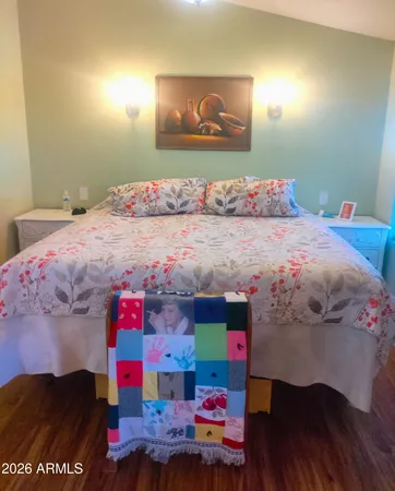 a bedroom with a bed and wooden floor