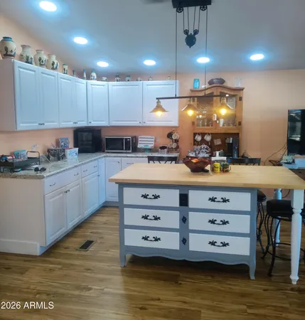 a kitchen with stainless steel appliances kitchen island granite countertop a stove a cabinets and a sink