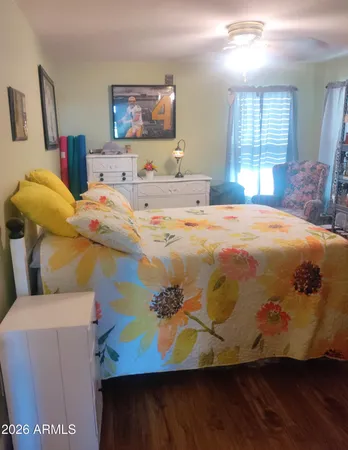 a bedroom with a bed and wooden floor