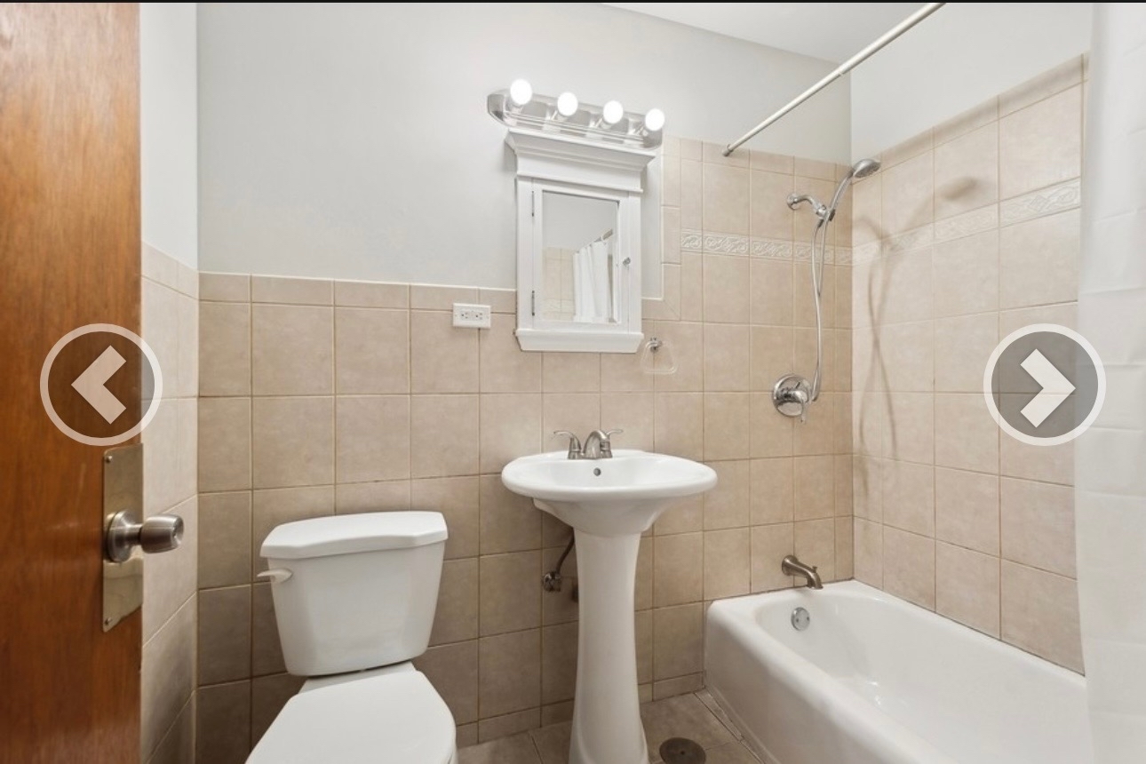 7019 North Ridge Boulevard, Unit 3B Chicago, IL 60645 - Photo 2 of 6 a bathroom with a sink a toilet and shower