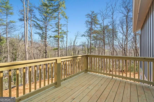 a view of balcony with wooden floor and fence