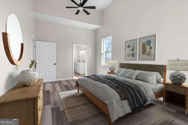 a bedroom with a bed a mirror and a window